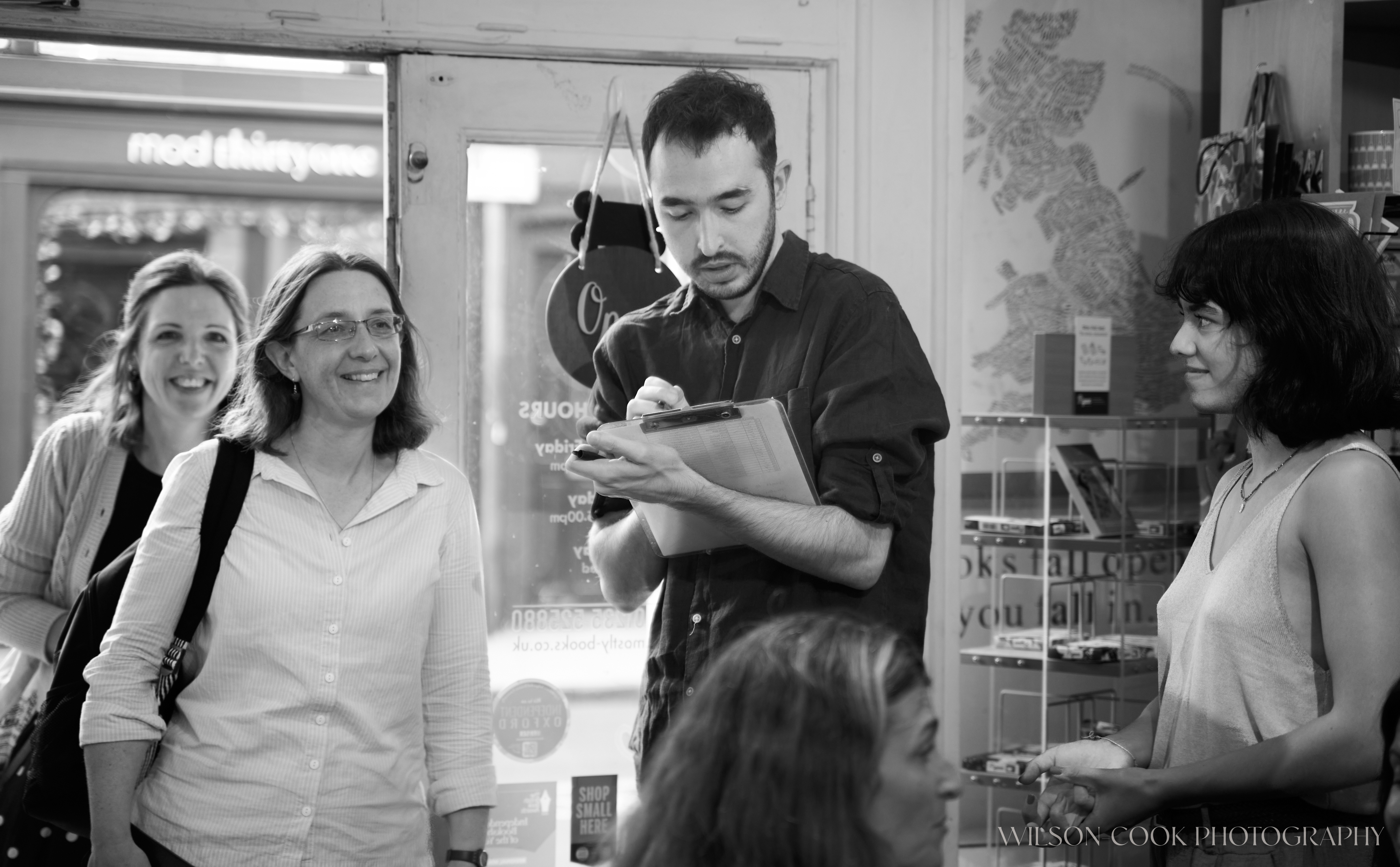 2025.  The organisers for an independent book shop welcome guests at the door, taken at Mostly Books, Abingdon.